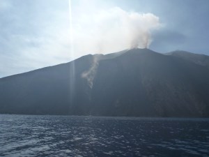 Stromboli erupting with hot rocks descending.