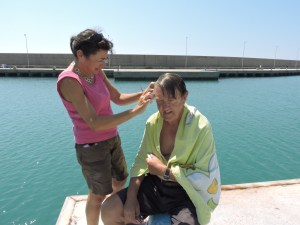 Sandy, from Billericay, cutting Terry's curls on the dock